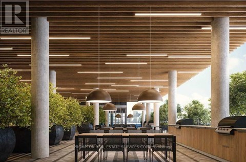 A modern outdoor seating area with a wooden ceiling and pillars.