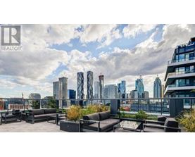 A rooftop patio with a view of a city skyline.