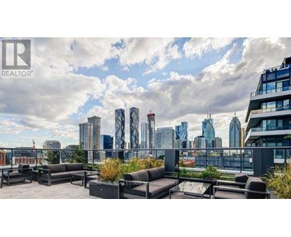 A rooftop patio with a view of a city skyline.