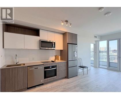 A modern kitchen with a stainless steel dishwasher and refrigerator.