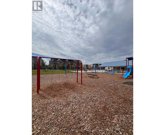A playground with a red swing set and a blue slide.