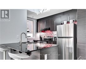 A modern kitchen with a sink and a refrigerator.