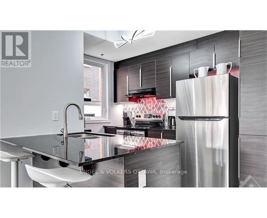 A modern kitchen with a sink and a refrigerator.
