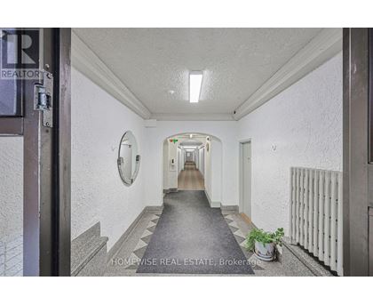 A hallway with a sign that says "HOMEWISSE REAL ESTATE Brokerage".