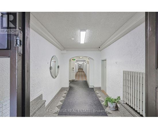 A hallway with a sign that says "HOMEWISSE REAL ESTATE Brokerage".