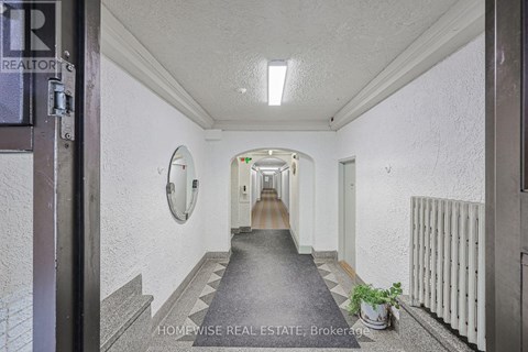 A hallway with a sign that says "HOMEWISSE REAL ESTATE Brokerage".