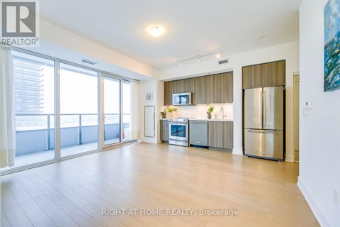 A spacious kitchen with a refrigerator, microwave, and oven.