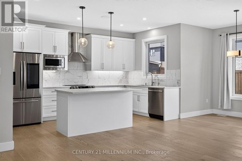 A modern kitchen with white cabinets and a large island.