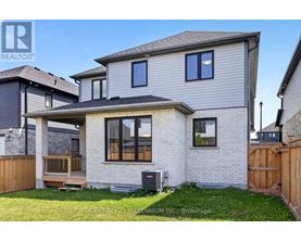 A house with a grey roof and a wooden fence in front.