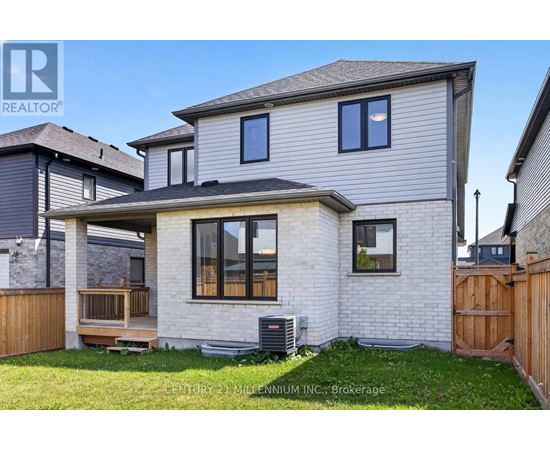 A house with a grey roof and a wooden fence in front.