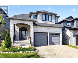 A modern house with a grey garage door and a stone facade.