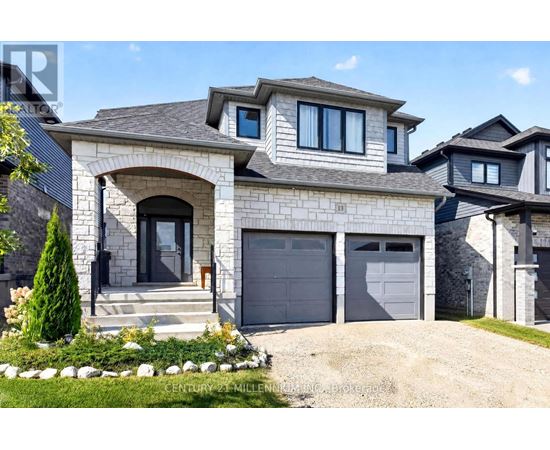 A modern house with a grey garage door and a stone facade.