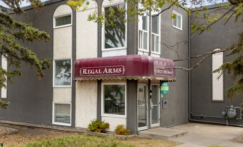 A building with a red awning that says Regal Arms.
