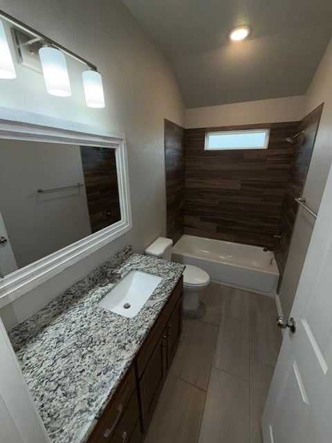 A bathroom with a sink, toilet, and bathtub.