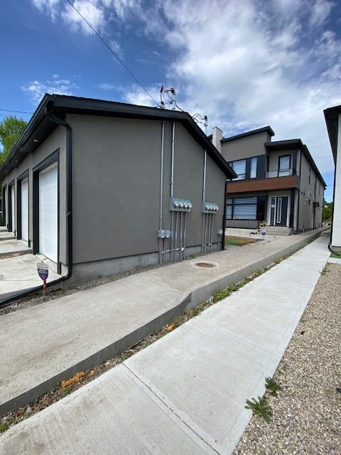 A grey house with a white door and a grey roof.