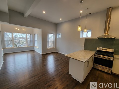 A spacious kitchen with a stove top oven and a counter top.
