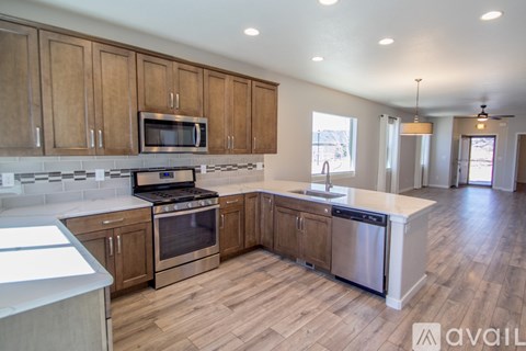 A kitchen with wooden cabinets and stainless steel appliances.
