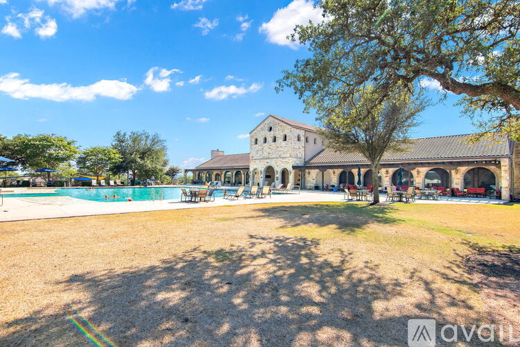 A large building with a pool in front of it.