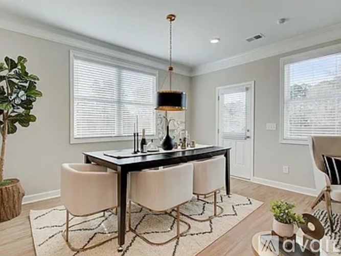A dining room with a table and chairs.