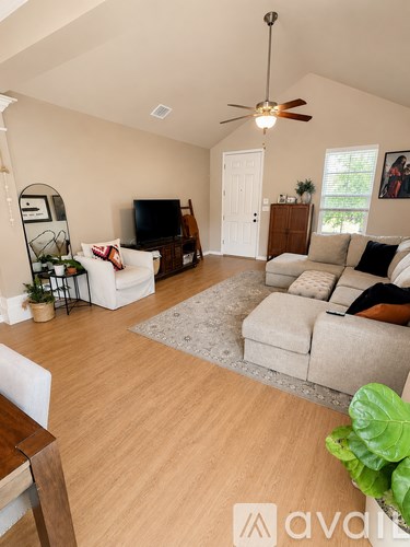 A living room with a white couch and a television.