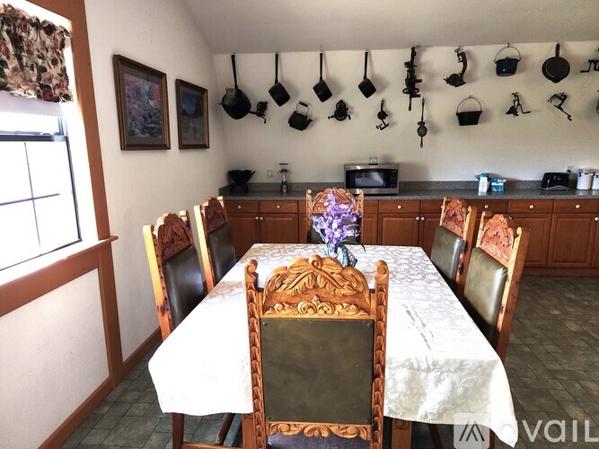 A dining room with a table set for four.
