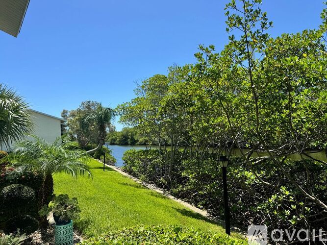 A lush green garden with a clear blue sky in the background.