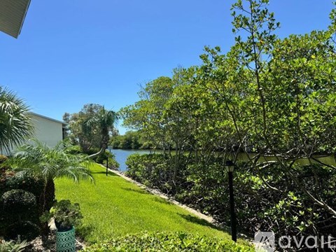 A lush green garden with a clear blue sky in the background.