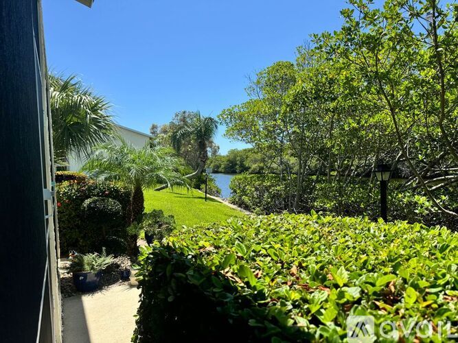 A lush green garden with a clear blue sky in the background.