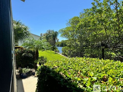 A lush green garden with a clear blue sky in the background.