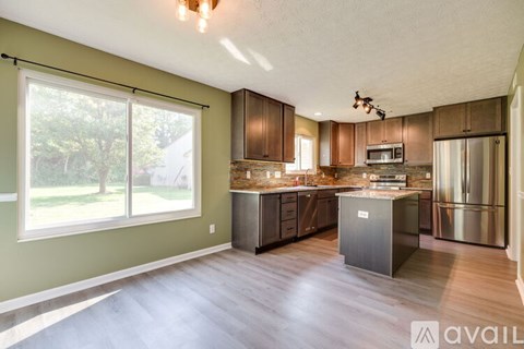 A kitchen with wooden cabinets and a center island.
