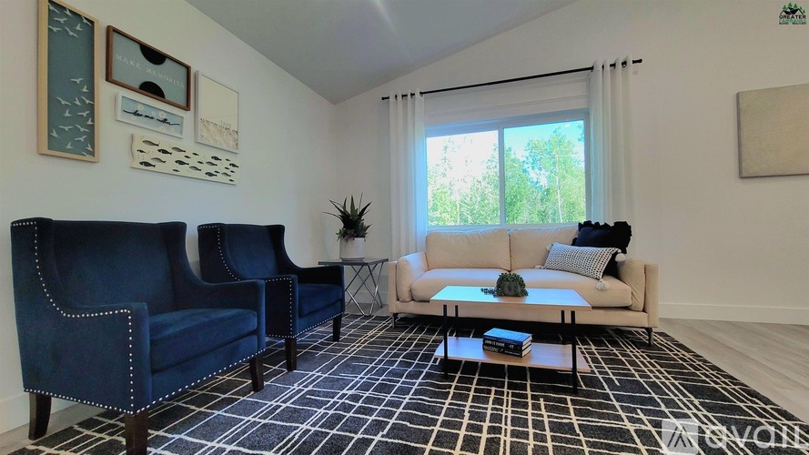 A living room with a blue couch and a white couch.