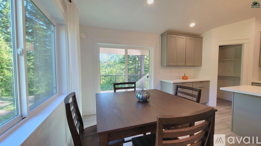 A dining room with a wooden table and chairs.