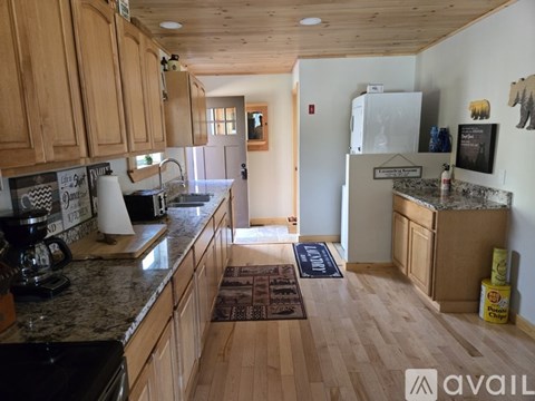 A kitchen with wooden cabinets and a granite countertop.