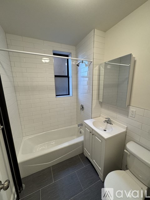 A bathroom with a tub, sink, and toilet.