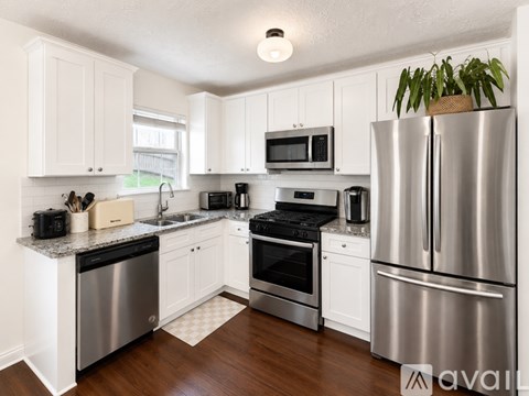 A kitchen with white cabinets and stainless steel appliances.