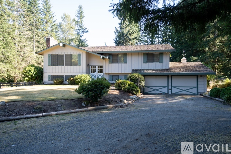 A house with a white garage door is for sale.