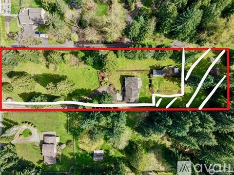 A red rectangle is drawn on a satellite image of a green area with a house and a tree.