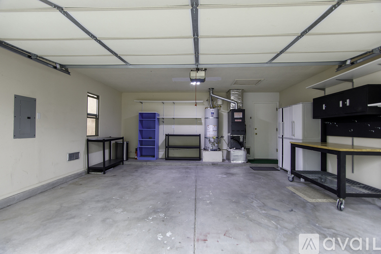A large, empty industrial space with a concrete floor and white walls.