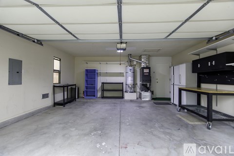 A large, empty industrial space with a concrete floor and white walls.