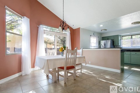 A kitchen with a table and chairs in the middle of the room.