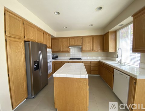 A kitchen with wooden cabinets and a white countertop.