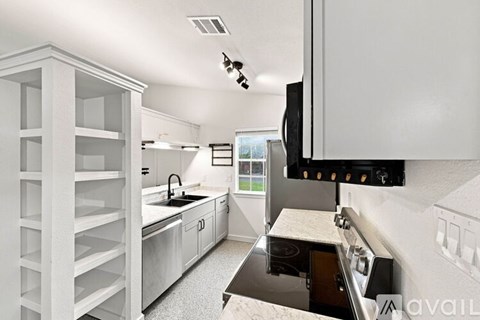 A modern kitchen with a black stove top oven.