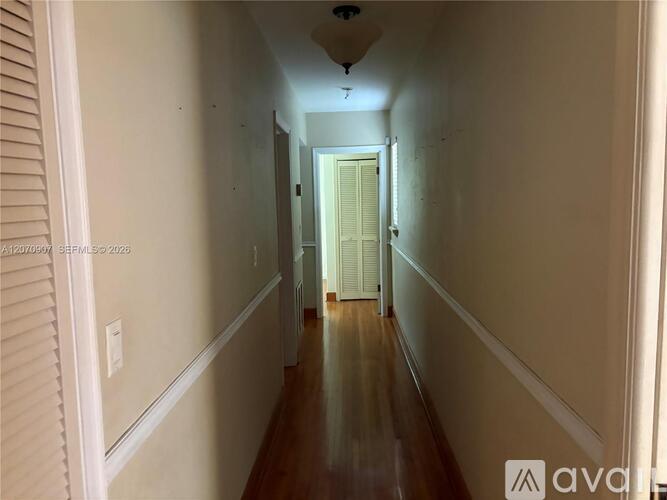 A long hallway with a door at the end.