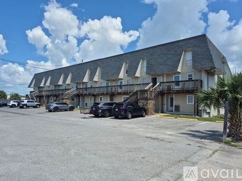 A building with a parking lot in front of it.