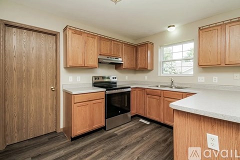 A kitchen with wooden cabinets and a white countertop.
