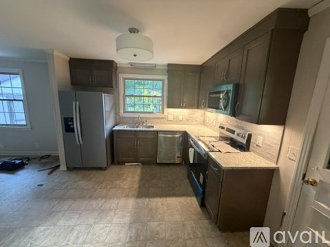 A kitchen with a window above the sink.