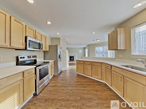 A kitchen with wooden cabinets and stainless steel appliances.