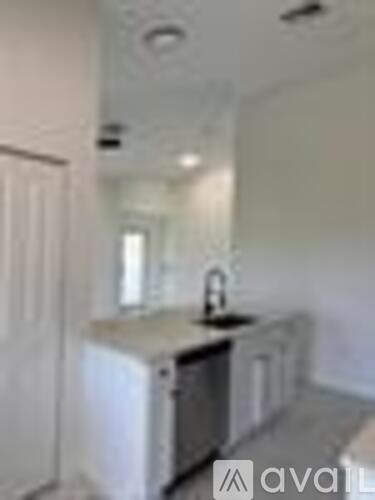 A kitchen with a sink and a dishwasher.