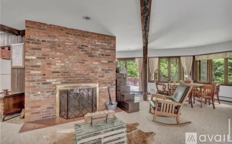 A living room with a fireplace and a dog.