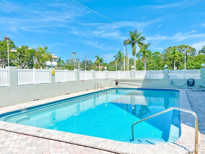 A rectangular pool with a metal ladder on the side.